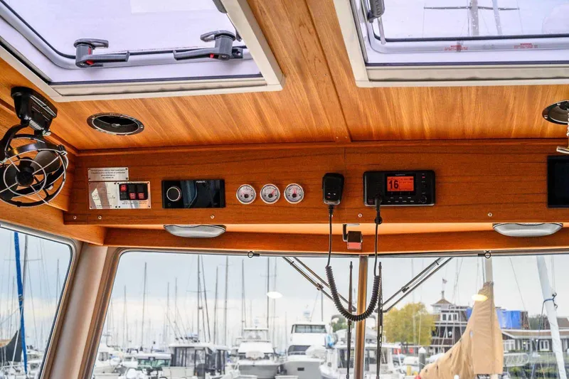  Yacht Photos Pics Interior view of 2024 Targa 30.1 boat dashboard with wooden finish and control panel.