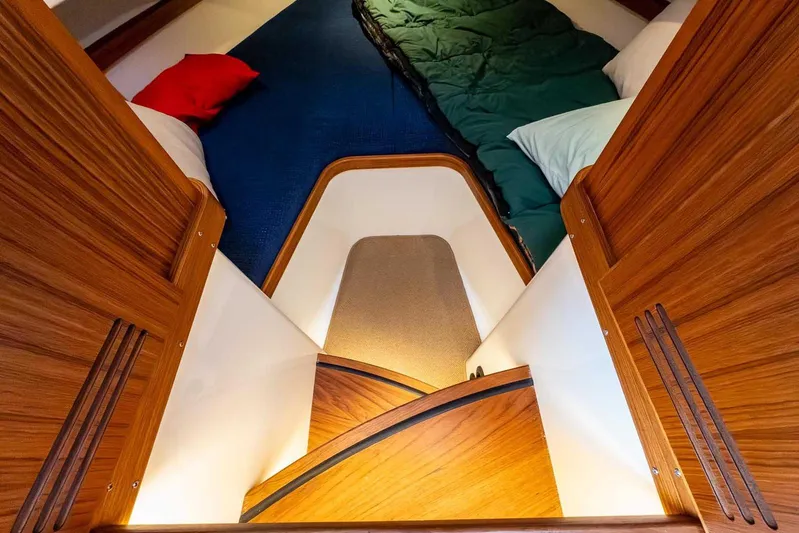  Yacht Photos Pics 2024 Targa 30.1 cabin interior with wooden finish and cozy bedding.
