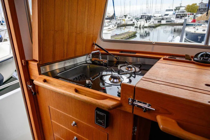  Yacht Photos Pics 2024 Targa 30.1 yacht kitchen with stove and sink, docked at marina.