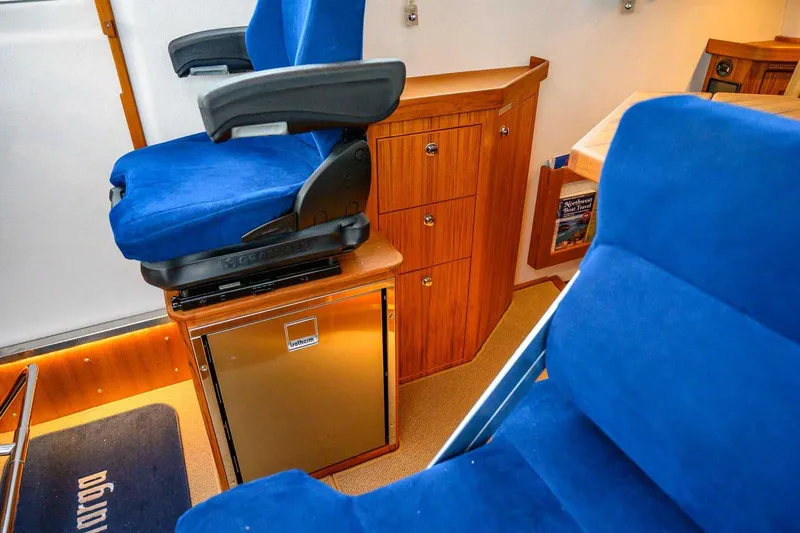  Yacht Photos Pics 2024 Targa 30.1 interior with blue seats and wooden cabinetry.