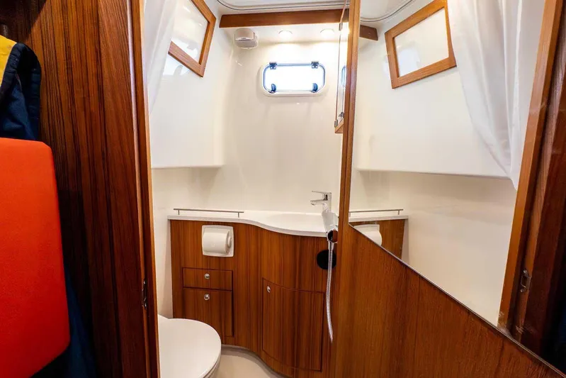  Yacht Photos Pics 2024 Targa 30.1 yacht bathroom with wooden cabinetry and modern fixtures.