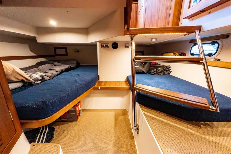  Yacht Photos Pics 2024 Targa 30.1 cabin interior with cozy beds and wooden accents.
