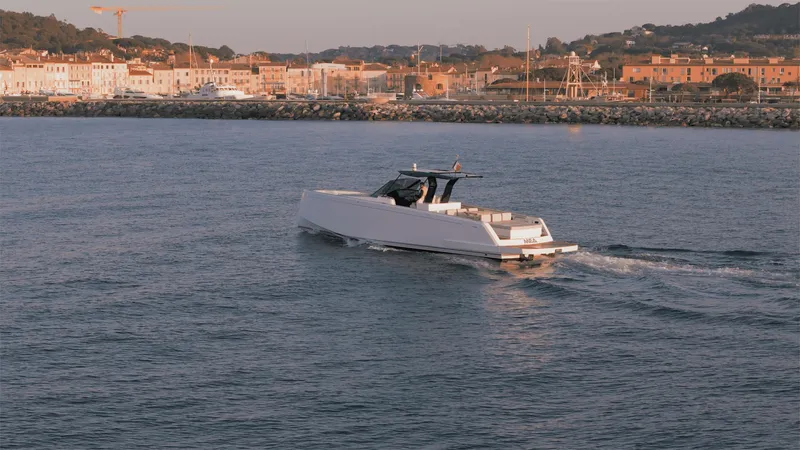 Mea Yacht Photos Pics 2022 Pardo Yachts 43 cruising near a coastal town at sunset.