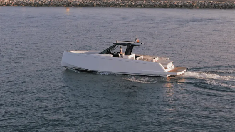 Mea Yacht Photos Pics 2022 Pardo Yachts 43 cruising on calm waters near a rocky shoreline.