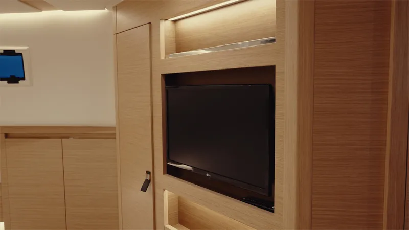 Mea Yacht Photos Pics Luxurious interior of 2022 Pardo Yachts 43 with built-in TV and wooden cabinetry.