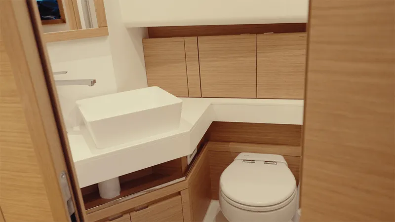 Mea Yacht Photos Pics Modern bathroom interior on 2022 Pardo Yachts 43, featuring sleek wood cabinetry and contemporary fixtures.