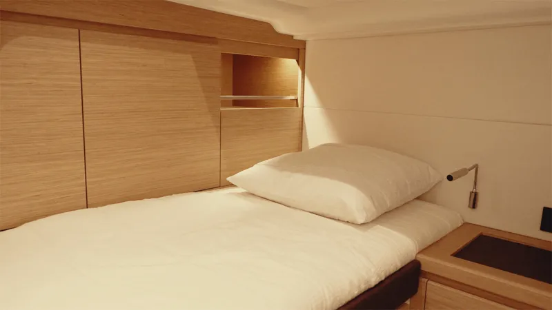 Mea Yacht Photos Pics Interior cabin of 2022 Pardo Yachts 43, featuring a cozy bed and wooden accents.