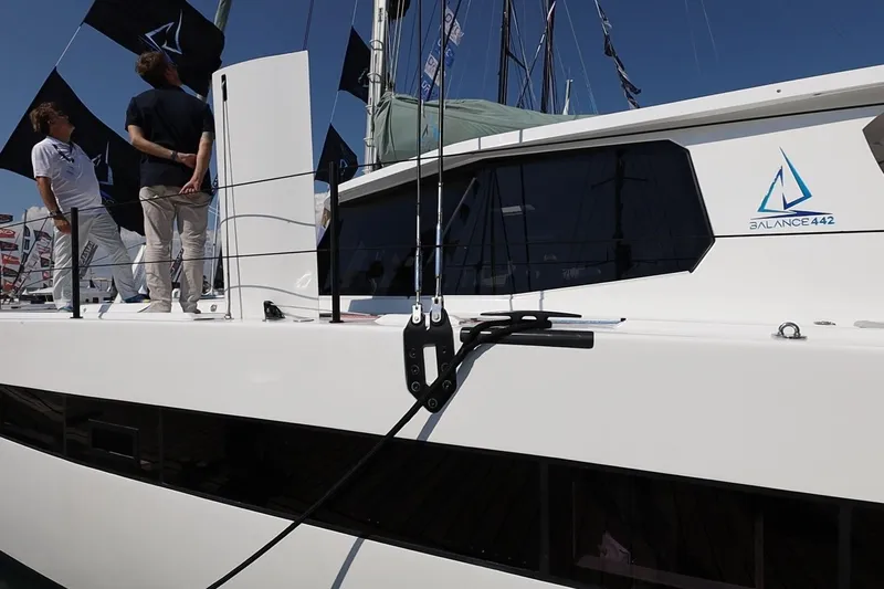 Lasai Yacht Photos Pics 2023 Balance 442 yacht with people on deck, featuring sleek design and modern aesthetics.