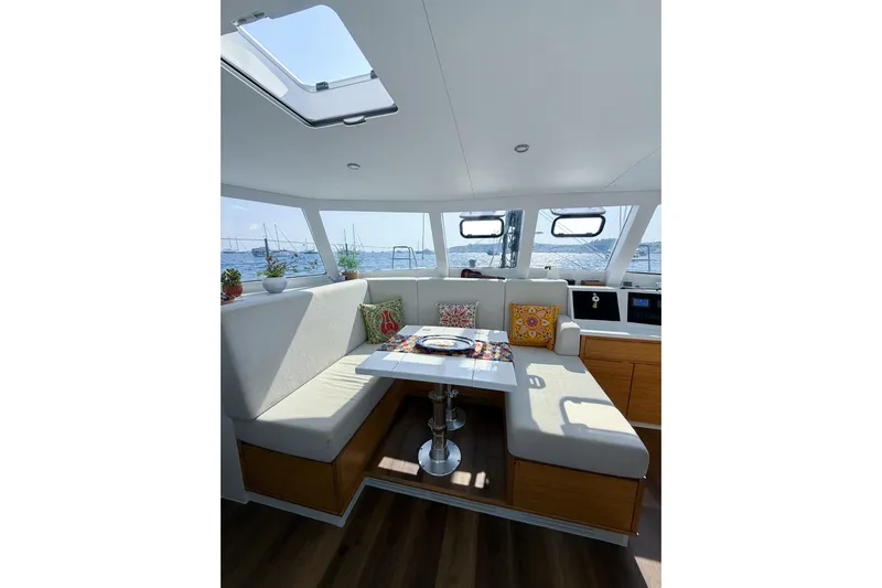Lasai Yacht Photos Pics Modern 2023 Balance 442 yacht interior with cozy seating and colorful cushions.