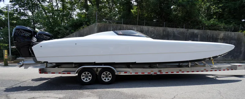  Yacht Photos Pics 2005 Doug Wright 32 powerboat on trailer, featuring dual outboard engines, parked outdoors.