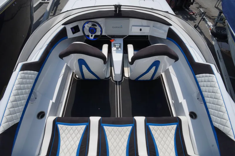  Yacht Photos Pics Interior of a 2005 Doug Wright 32 boat with modern seating and steering wheel.