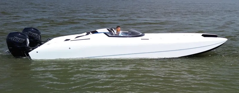  Yacht Photos Pics White Doug Wright 32 speedboat with dual 400 horsepower engines cruising on open water.