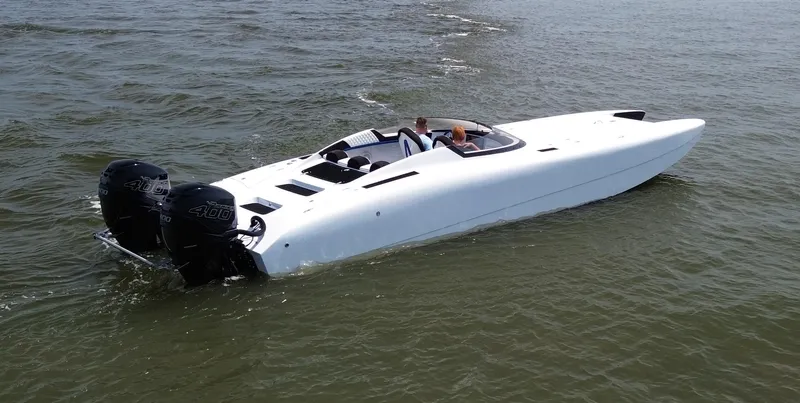  Yacht Photos Pics White Doug Wright 32 speedboat with dual engines cruising on open water.