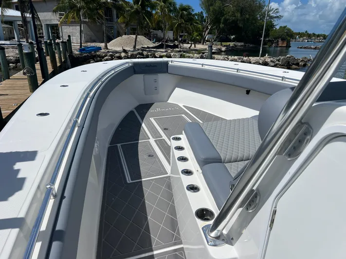  Yacht Photos Pics 2015 SeaHunter 41 Tournament boat interior with seating and rod holders, docked by tropical shoreline.