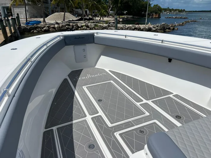  Yacht Photos Pics 2015 SeaHunter 41 Tournament boat deck with gray non-slip flooring, docked by the shore.