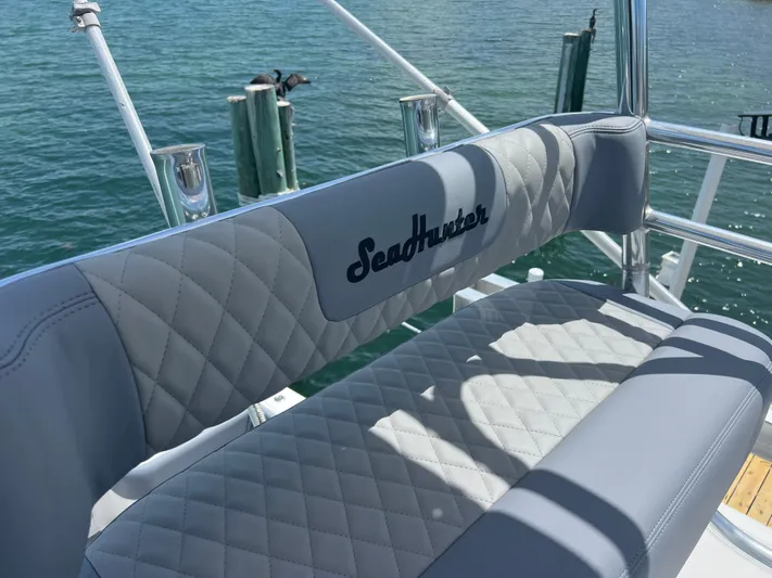  Yacht Photos Pics SeaHunter 41 Tournament 2015 boat seat with quilted design, docked by the water.