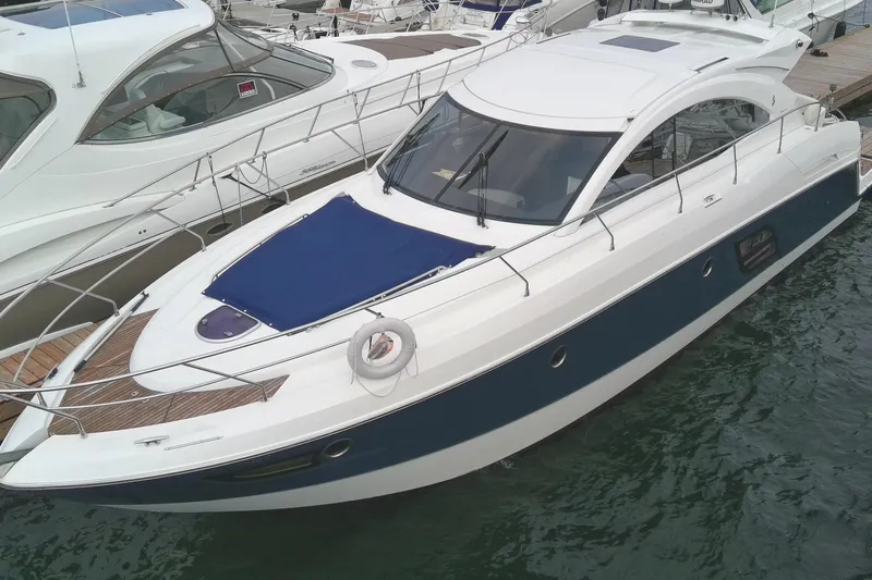  Yacht Photos Pics 2015 Beneteau Gran Turismo 49 yacht docked in marina, featuring sleek design and blue accents.