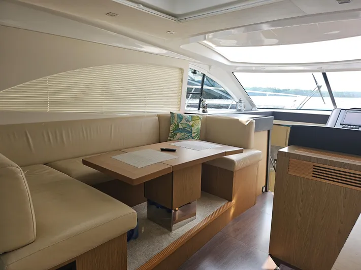  Yacht Photos Pics Luxurious interior of 2015 Beneteau Gran Turismo 49 yacht with elegant seating and table.