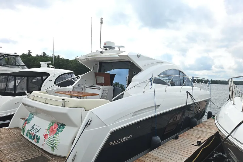  Yacht Photos Pics 2015 Beneteau Gran Turismo 49 yacht docked, featuring sleek design and spacious deck.