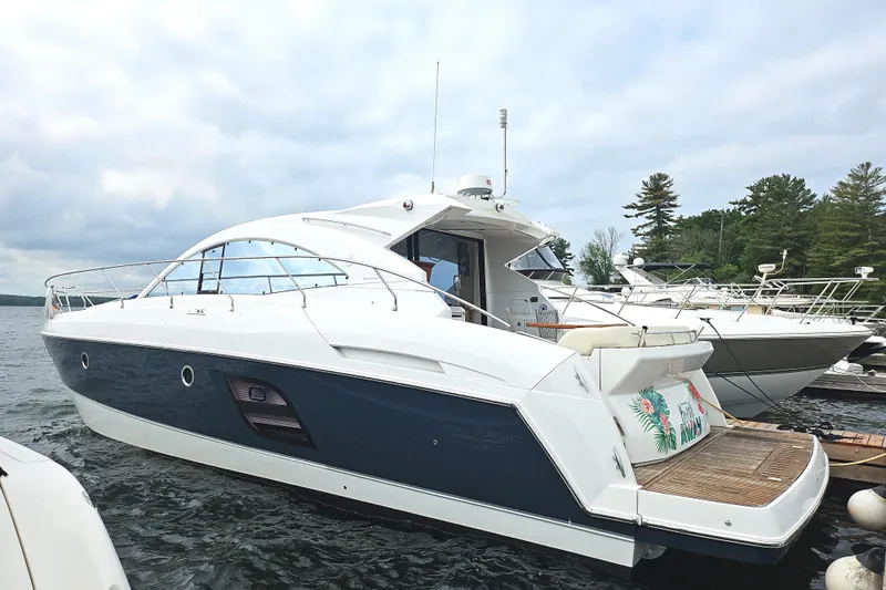  Yacht Photos Pics 2015 Beneteau Gran Turismo 49 yacht docked on a serene lake.