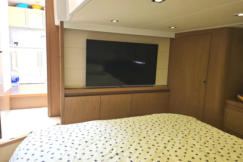  Yacht Photos Pics Luxurious cabin interior of 2015 Beneteau Gran Turismo 49 yacht with TV and modern decor.