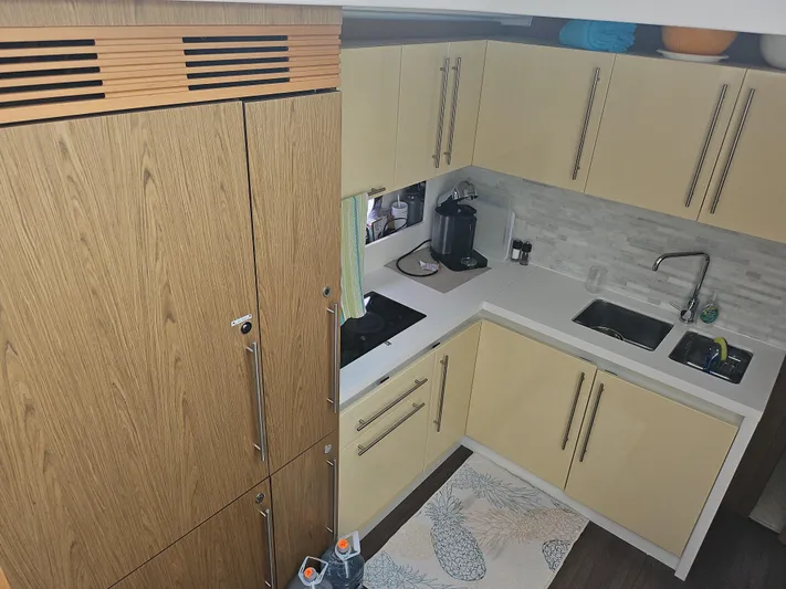  Yacht Photos Pics Modern kitchen interior on 2015 Beneteau GRAN TURISMO 49 yacht, featuring sleek cabinetry and appliances.