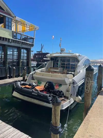  Yacht Photos Pics 2015 Beneteau Gran Turismo 49 yacht docked with inflatable boat at marina.