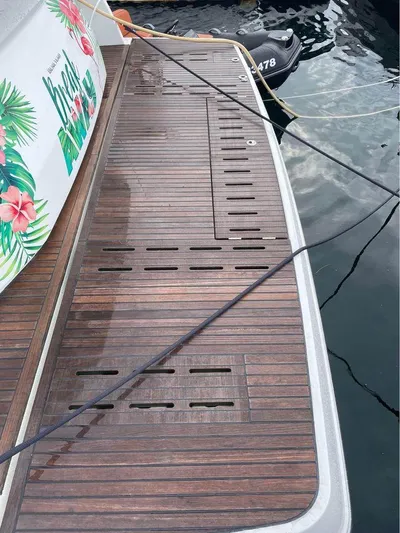  Yacht Photos Pics Teak deck of 2015 Beneteau Gran Turismo 49 yacht, docked by water.