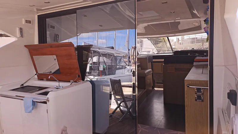  Yacht Photos Pics Interior view of 2015 Beneteau Gran Turismo 49 yacht, featuring kitchen and seating area.