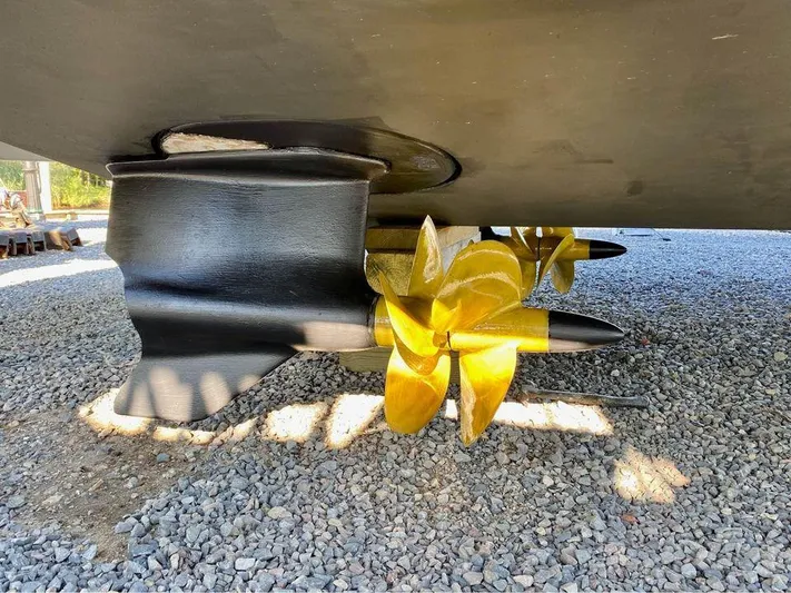  Yacht Photos Pics Propellers of 2015 Beneteau GRAN TURISMO 49 yacht on gravel surface.