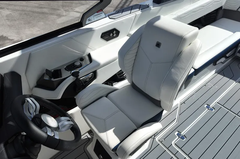  Yacht Photos Pics 2025 Nautique Super Air Nautique G25 interior with sleek white captain's chair and modern controls.