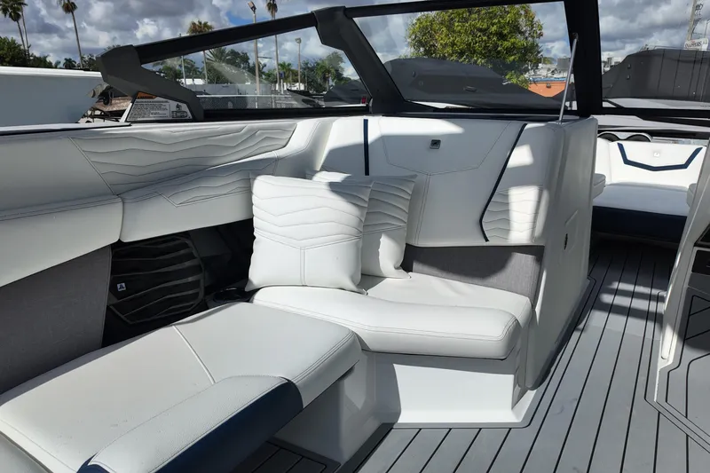  Yacht Photos Pics 2025 Nautique Super Air Nautique G25 interior with white seating and modern design.