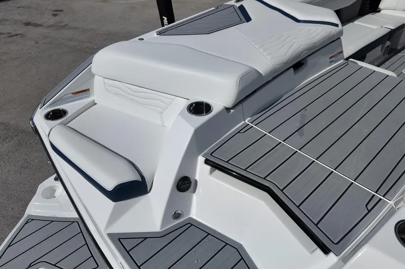  Yacht Photos Pics 2025 Nautique Super Air Nautique G25 boat deck with cushioned seating and cup holders.
