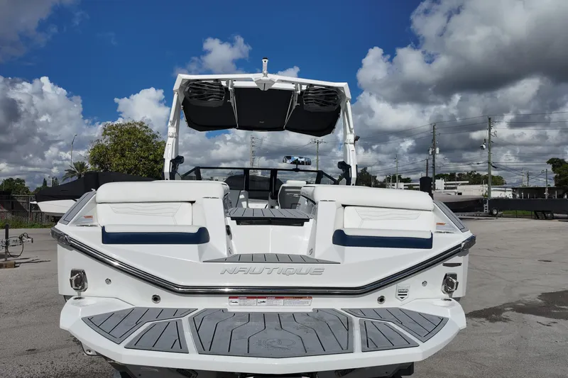  Yacht Photos Pics 2025 Nautique Super Air Nautique G25 boat, rear view, under cloudy sky.