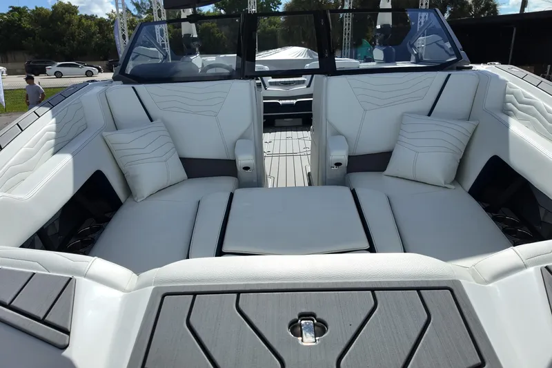  Yacht Photos Pics 2025 Nautique Super Air Nautique G25 interior with luxurious white seating and cushions.