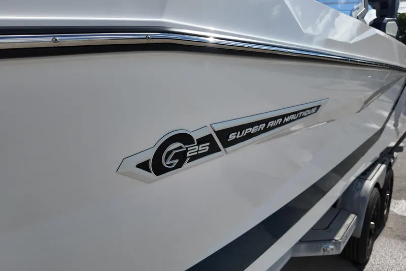  Yacht Photos Pics 2025 Nautique Super Air Nautique G25 boat side view with logo detail.