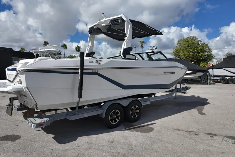  Yacht Photos Pics 2025 Nautique Super Air Nautique G25 boat on trailer under a partly cloudy sky.