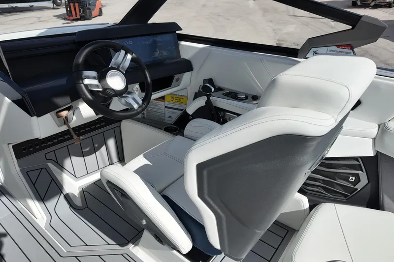  Yacht Photos Pics Interior of 2025 Nautique Super Air Nautique G25 boat, featuring modern steering and controls.