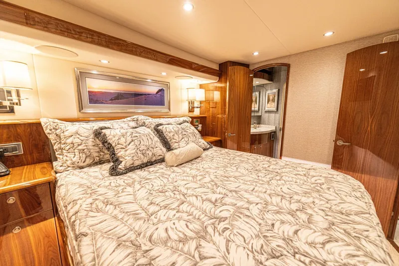 El Lobo Yacht Photos Pics Luxurious bedroom interior of 2020 Viking 58 Convertible yacht with elegant bedding and wood finishes.