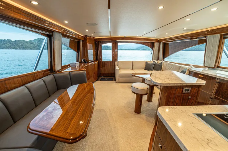 El Lobo Yacht Photos Pics Luxurious interior of 2020 Viking 58 Convertible yacht with elegant wood finishes and ocean view.