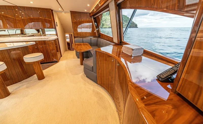 El Lobo Yacht Photos Pics Luxurious interior of 2020 Viking 58 Convertible yacht with polished wood and ocean view.