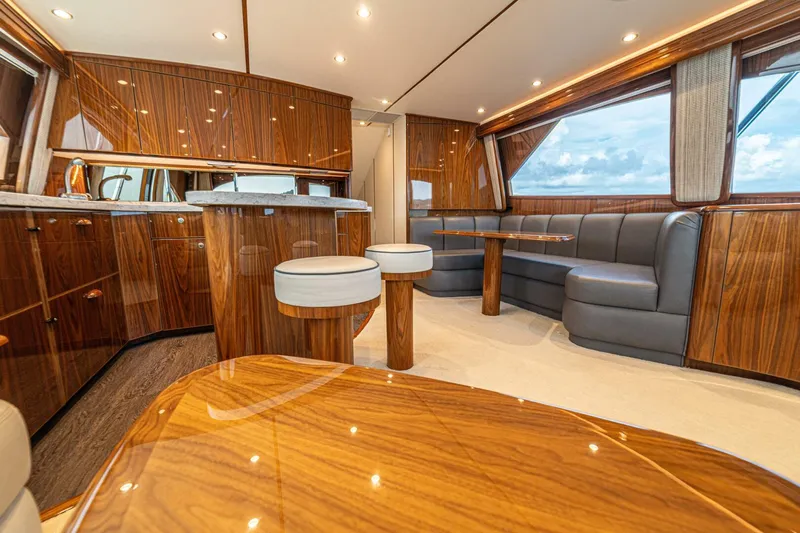El Lobo Yacht Photos Pics Luxurious interior of 2020 Viking 58 Convertible yacht with wood finishes and plush seating.