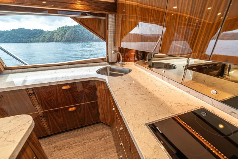El Lobo Yacht Photos Pics Luxurious kitchen interior of 2020 Viking 58 Convertible yacht with ocean view.