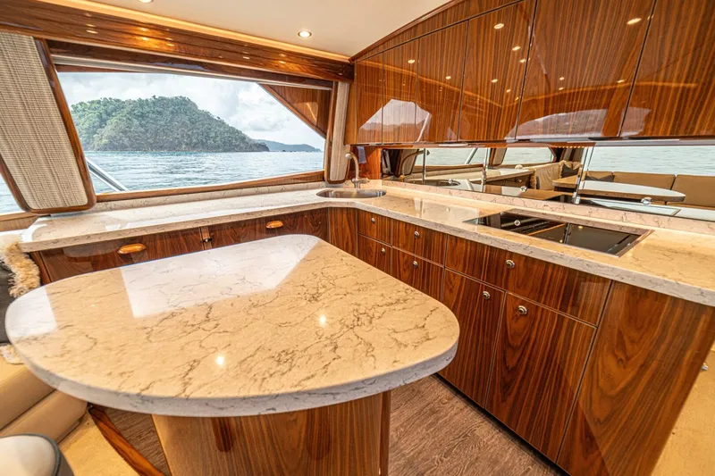 El Lobo Yacht Photos Pics Luxurious interior of 2020 Viking 58 Convertible yacht with elegant wood and marble finishes.