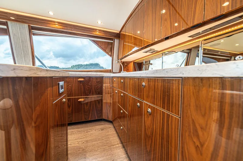 El Lobo Yacht Photos Pics Luxurious interior of 2020 Viking 58 Convertible yacht with polished wood cabinetry.