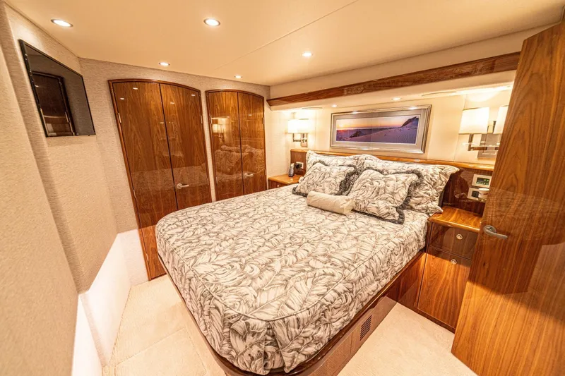 El Lobo Yacht Photos Pics Luxurious bedroom interior of 2020 Viking 58 Convertible yacht with elegant wood finishes.