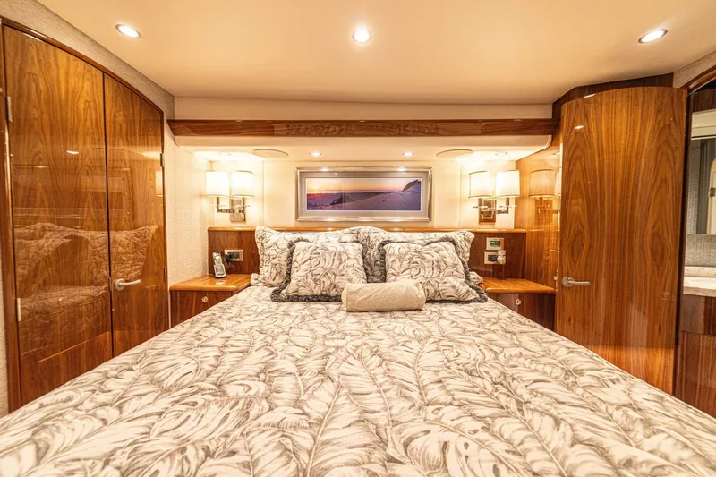 El Lobo Yacht Photos Pics Luxurious bedroom interior of 2020 Viking 58 Convertible yacht with elegant wood finishes.