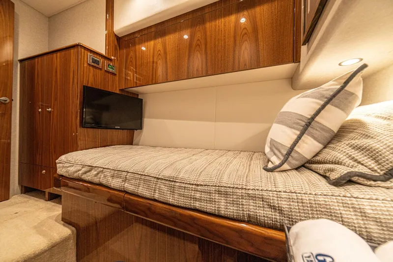 El Lobo Yacht Photos Pics Luxurious interior of 2020 Viking 58 Convertible yacht with cozy bed and TV.