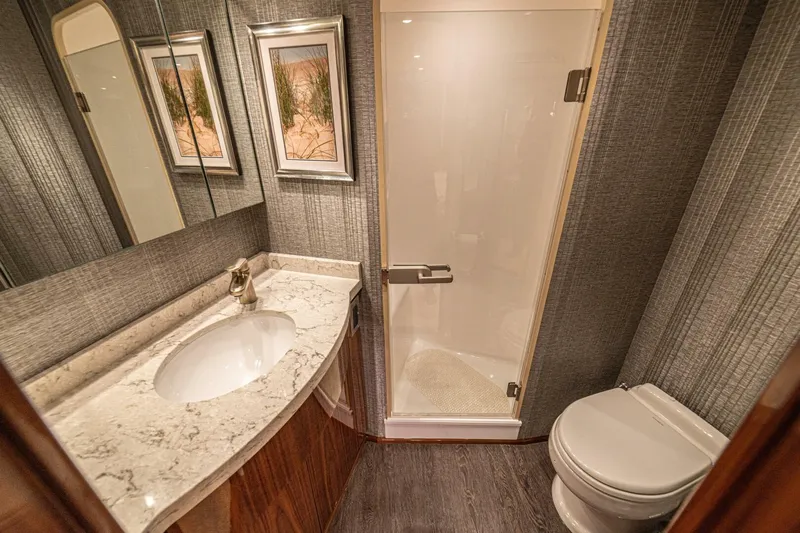 El Lobo Yacht Photos Pics Luxurious bathroom in 2020 Viking 58 Convertible yacht with marble countertop and glass shower.