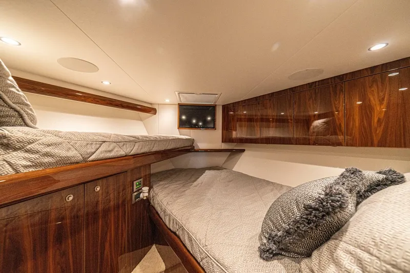 El Lobo Yacht Photos Pics Luxurious cabin interior of 2020 Viking 58 Convertible yacht with cozy bedding.